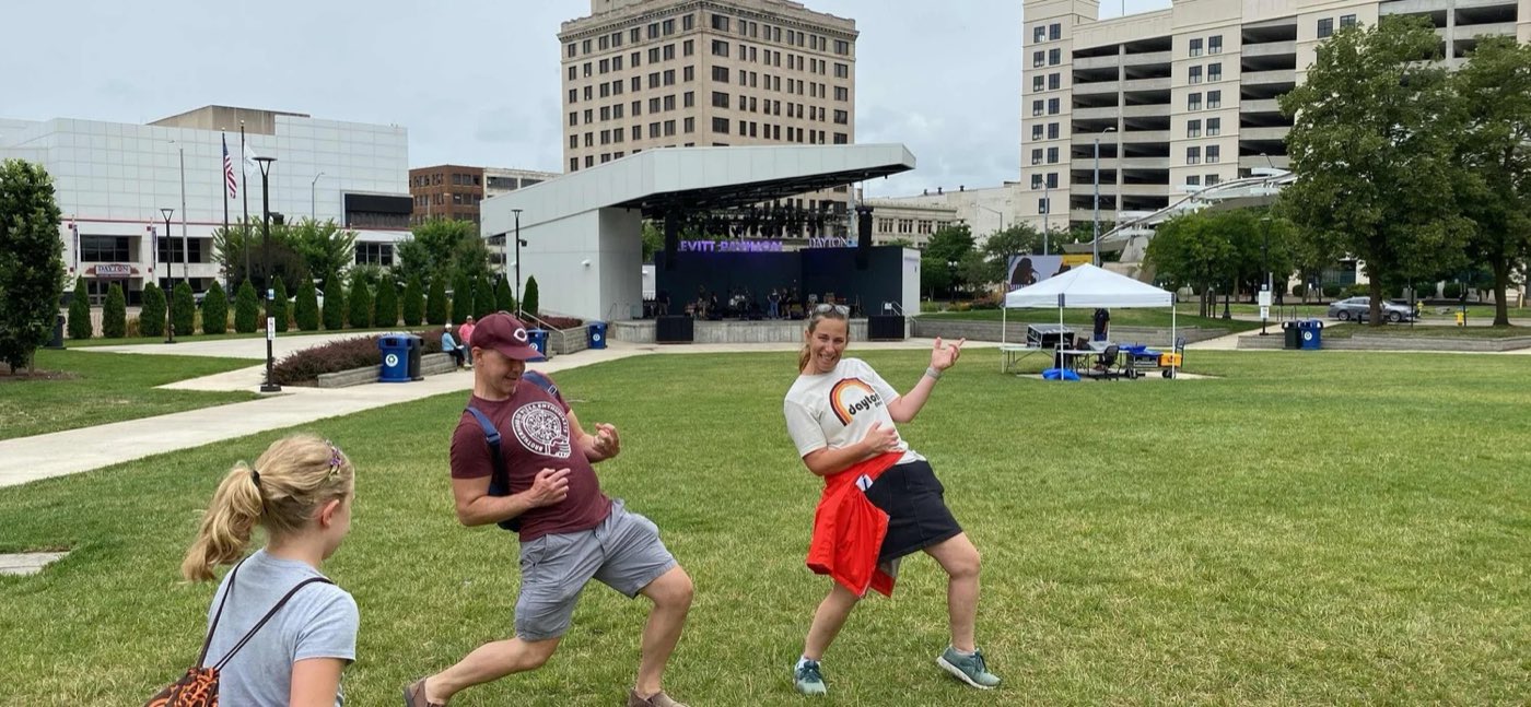 Players strike poses on a park lawn